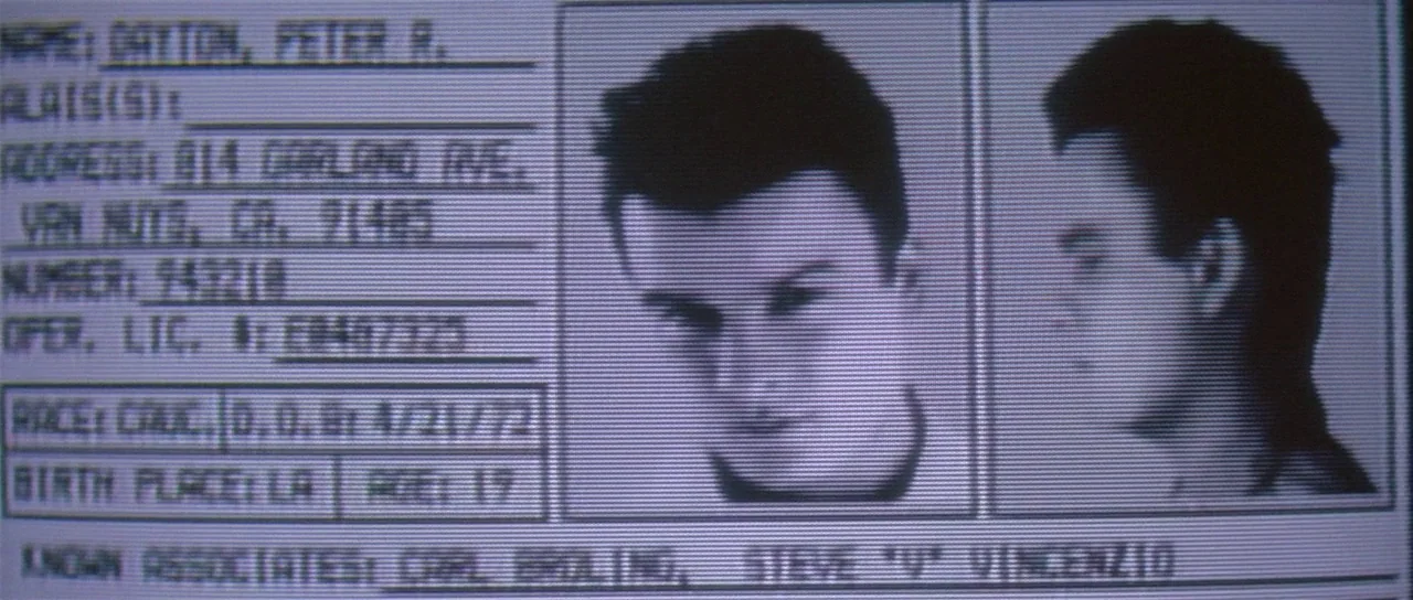 Lost Highway (1997) movie still: closeup — A digital computer screen shows a mugshot profile for an individual named Peter R. Dayton. The screen…