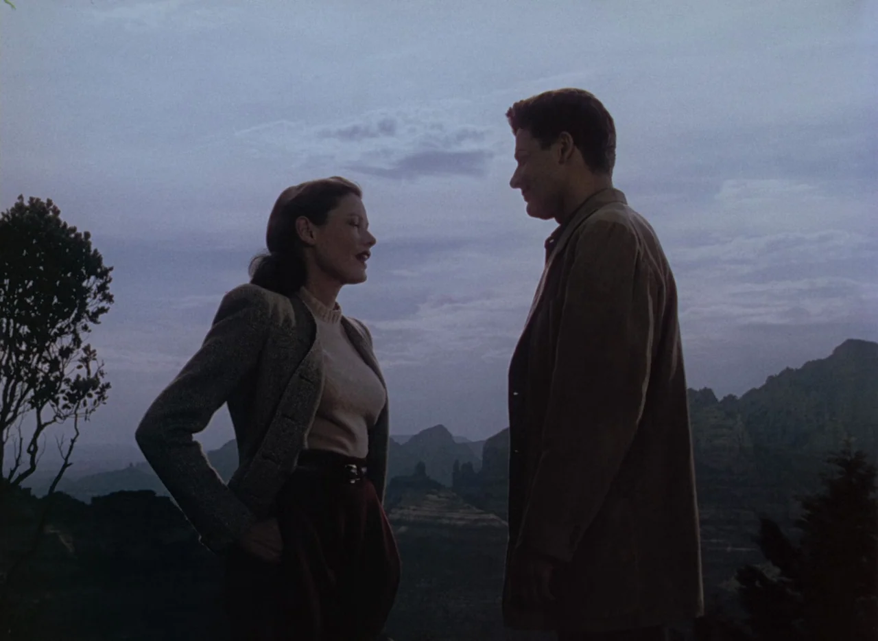 Leave Her To Heaven (1945) movie still: medium — A man and a woman stand on a remote mountain overlook at twilight. The pair face each other in…