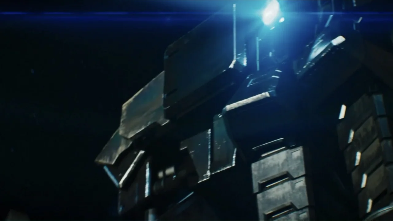 Robot Overlords (2015) movie still: closeup — A massive dark metal robotic frame occupies the frame against a black void. A bright blue light flares…