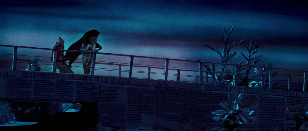 Bunny and the Bull (2009) movie still: wide — A bridge railing constructed from paper and wood sits against a deep blue sky. A boy stands beside a…