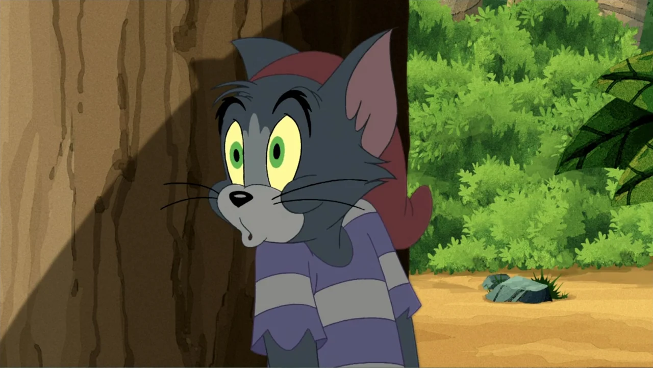 Tom and Jerry: Shiver Me Whiskers (2006) movie still: medium — A 2D animated jungle environment features dense green foliage and a large brown tree.…