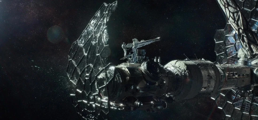 The Midnight Sky (2020) movie still: wide — A complex modular space station with large hexagonal solar arrays floats against deep space. The…