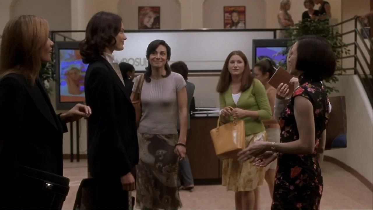 How to Lose a Guy in 10 Days (2003) movie still: medium — A corporate office lobby features beige walls and a reception desk in the background.…