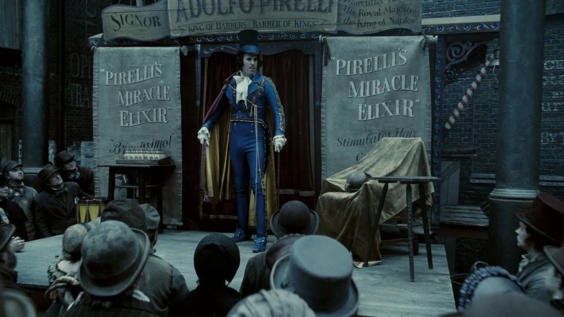 Sweeney Todd: The Demon Barber of Fleet Street (2007) movie still: fullbody — A man in a vibrant uniform stands on a makeshift wooden platform…