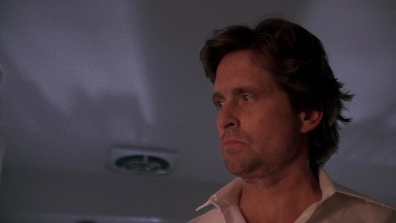 Fatal Attraction (1987) movie still: closeup — A dimly lit interior room features a ceiling exhaust vent visible in the background. A man stares…