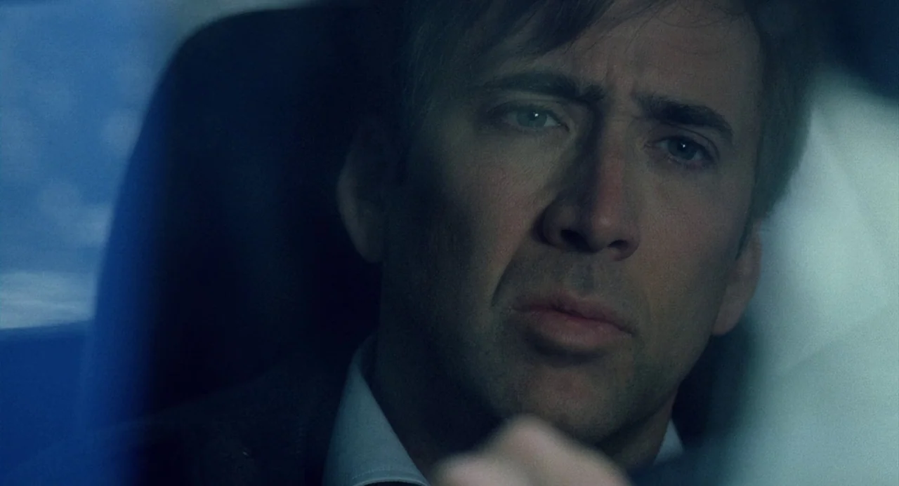 The Weather Man (2005) movie still: closeup — The interior of a moving vehicle at night with dim, cold blue illumination. A man sits in the driver…