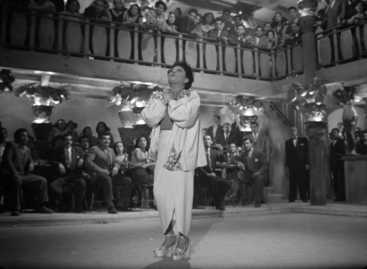 Victims of Sin (1951) movie still: fullbody — A crowded mid-1940s nightclub with balcony seating and tables surrounding a central dance floor. A…