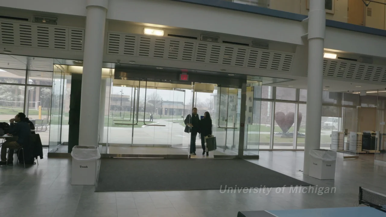 Kill Chain: The Cyber War on America's Elections (2020) movie still: wide — A modern building lobby features glass walls, white support pillars, and…