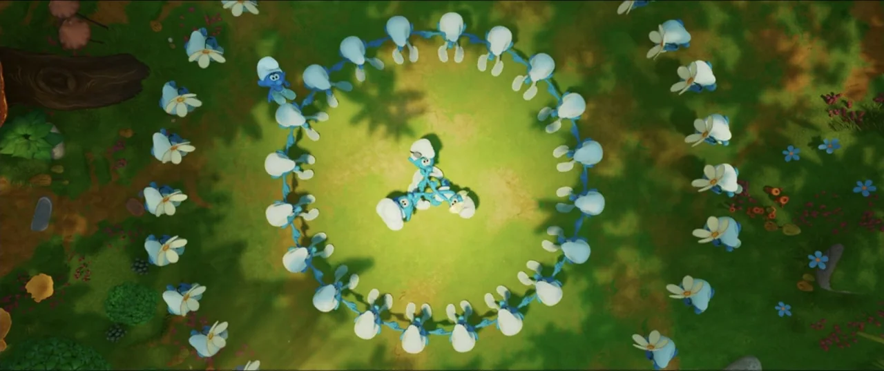 Smurfs (2025) movie still: wide — A clearing in a lush green meadow is covered in scattered small white flowers. A large group of blue cartoon…