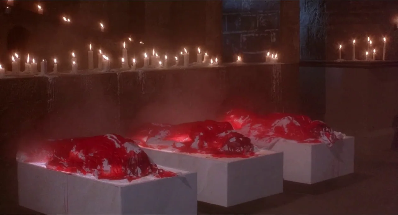 Hellbound: Hellraiser II (1988) movie still: wide — Three rectangular white stone slabs are arranged in a dimly lit, vaulted stone structure. Each…