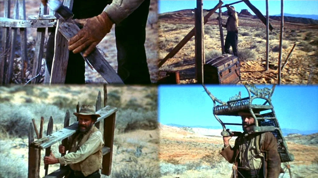 The Ballad of Cable Hogue (1970) movie still: medium — A man walks through a vast desert carrying a wooden chair on his shoulders. The barren…