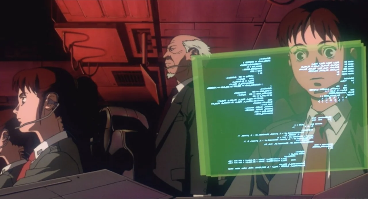Ghost in the Shell (1995) movie still: medium — A dimly lit command center features multiple holographic displays glowing with green data text. Two…