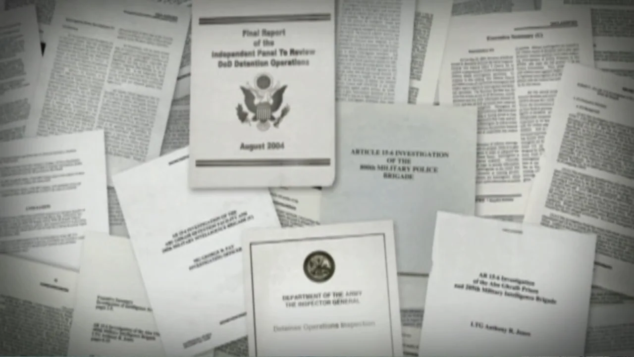 Ghosts of Abu Ghraib (2007) movie still: establishing — A pile of official military investigation reports and detentions papers lies on a flat…