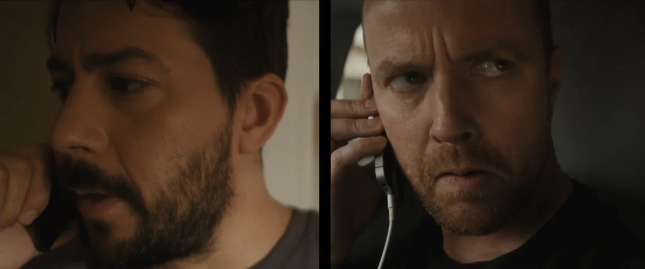 Stalker (2020) movie still: closeup — A split screen shows two men in separate locations speaking on mobile phones. Each man holds a phone to his…