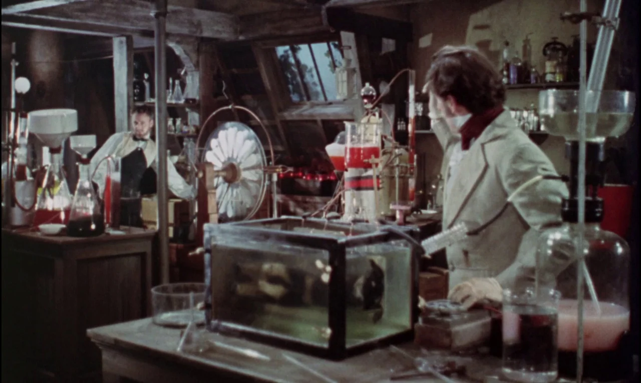 The Curse of Frankenstein (1957) movie still: medium — A cluttered 19th-century attic filled with complex glassware, bubbling red liquids, and…