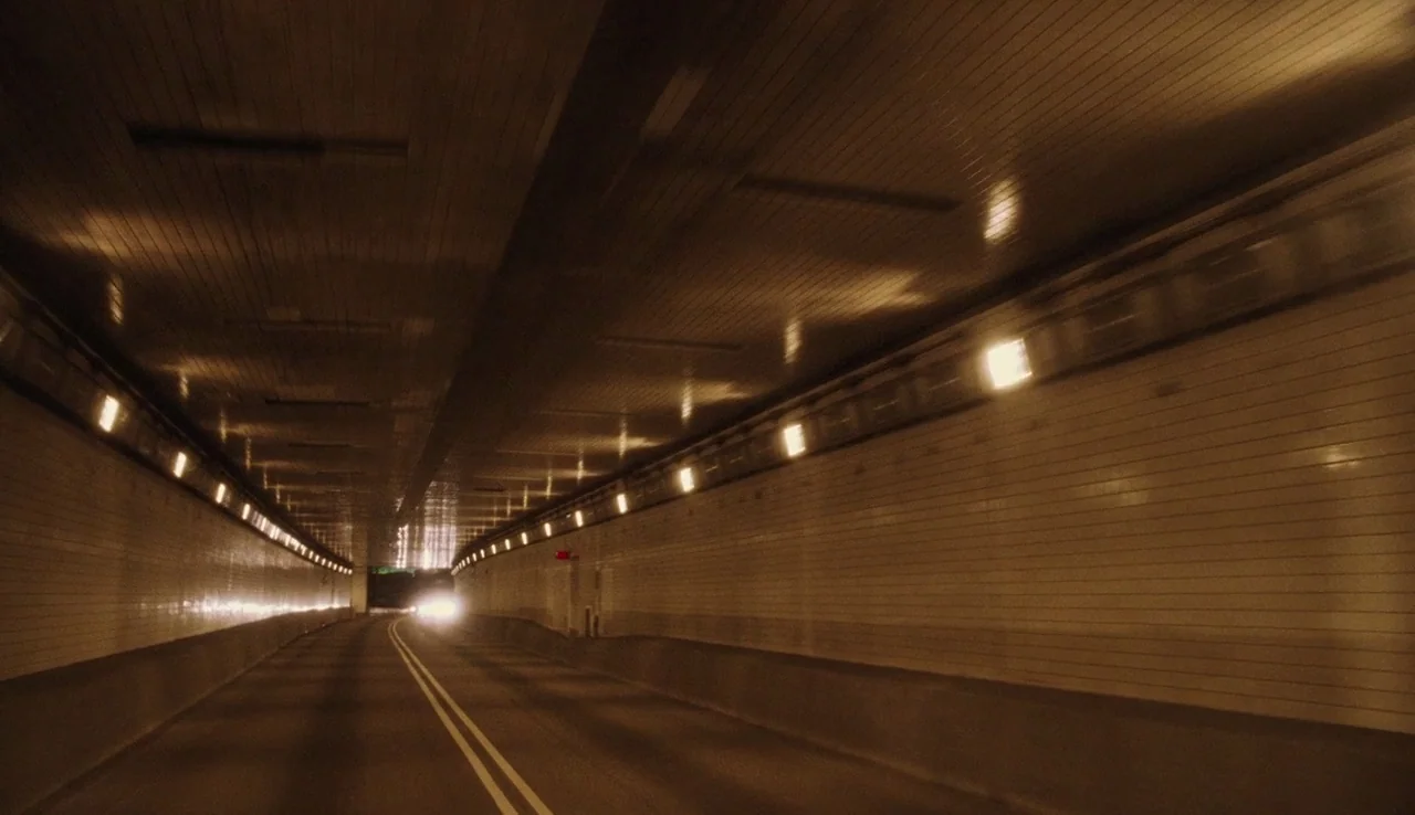 The Perks of Being A Wallflower (2012) movie still: establishing — A long, curved underground road tunnel features tiled walls and evenly spaced…