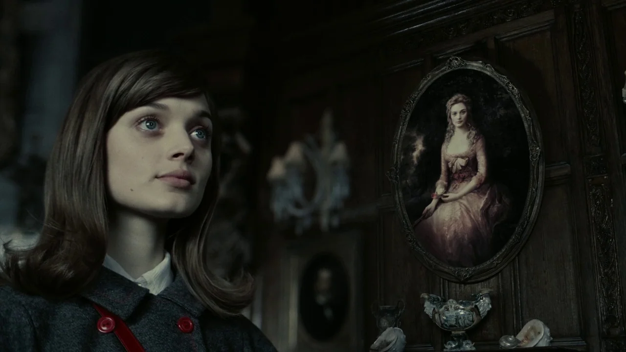 Dark Shadows (2012) movie still: medium — A wood-paneled room with ornate portraits hung on the dark, paneled walls. A young woman stands looking at…