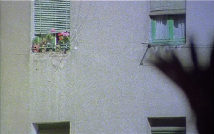 Pepi, Luci, Bom and Other Girls Like Mom (1980) movie still: establishing — The exterior facade of a plain, light-colored apartment building has…
