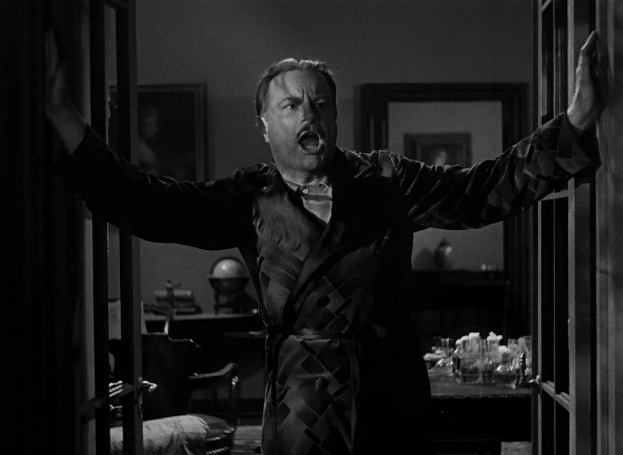 The Invisible Man (1933) (1933) movie still: medium — A dark, wood-paneled room contains a desk with a globe and glassware. A man in a dressing gown…