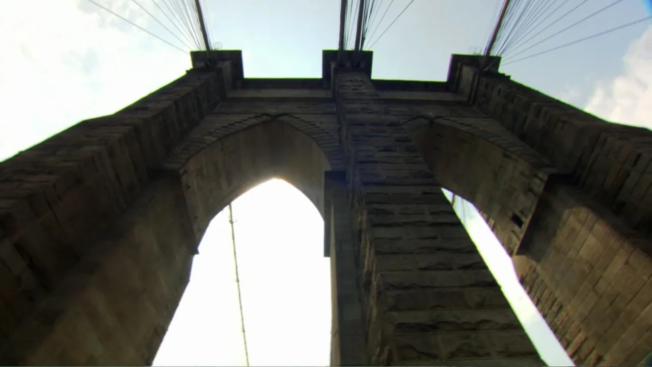 David McCullough: Painting with Words (2008) movie still: establishing — A stone bridge tower with pointed arches rises against a clear daytime sky.…