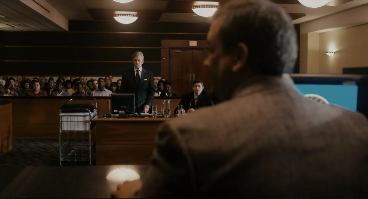 Beyond a Reasonable Doubt (2009) movie still: medium — A courtroom interior features rows of wooden benches filled with a seated gallery audience. A…
