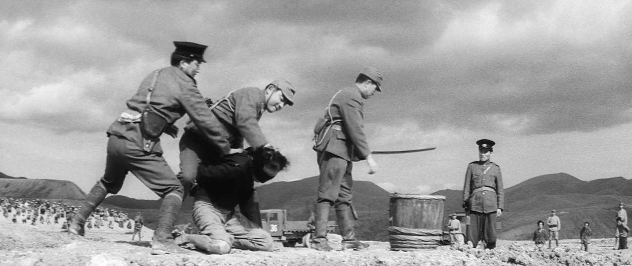 The Human Condition I: No Greater Love (1959) movie still: wide — A desolate mountainous area with a flat, dirt-covered foreground under an overcast…