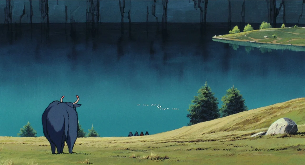 Castle in the Sky (1986) movie still: wide — A vast, deep blue lake is bordered by rolling grassy hills and pine trees. A large black bull stands in…