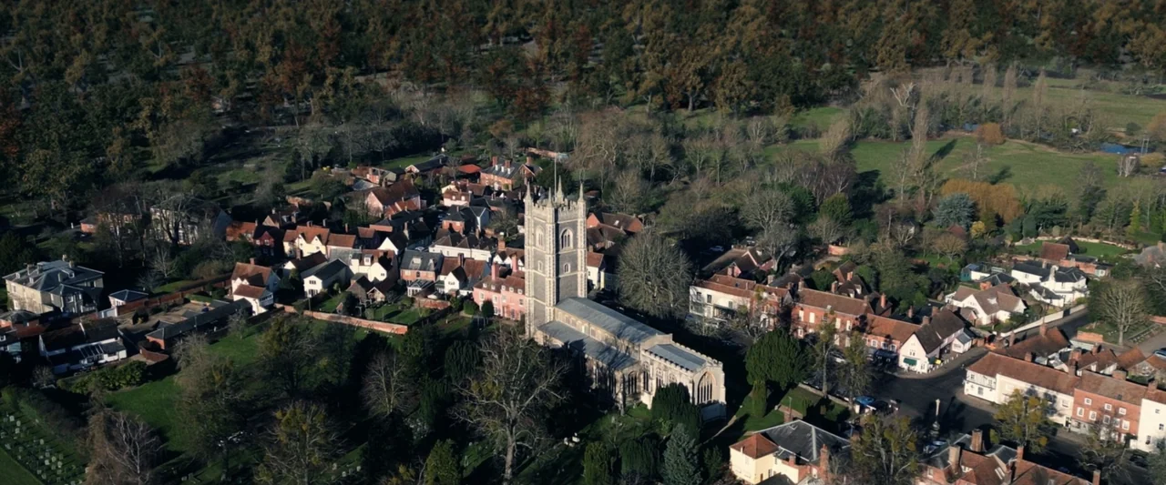 Winnie-the-Pooh: Blood and Honey 2 (2024) movie still: establishing — An aerial shot overlooks a dense English village with a central stone parish…
