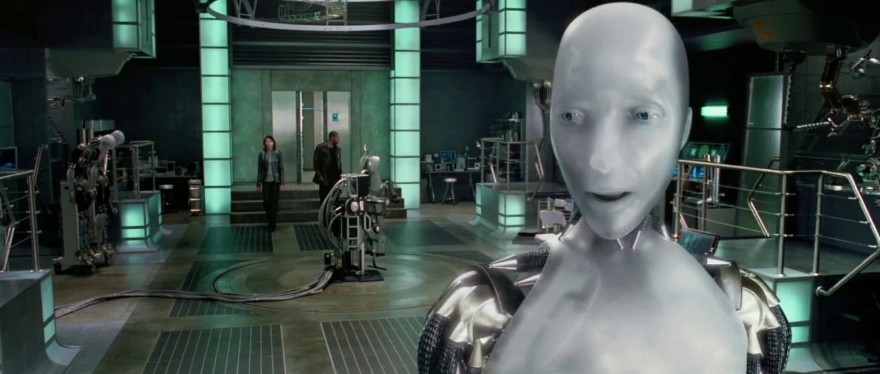 I, Robot (2004) movie still: medium — A high-tech laboratory features metal grating floors, glowing green pillars, and technical machinery. A…