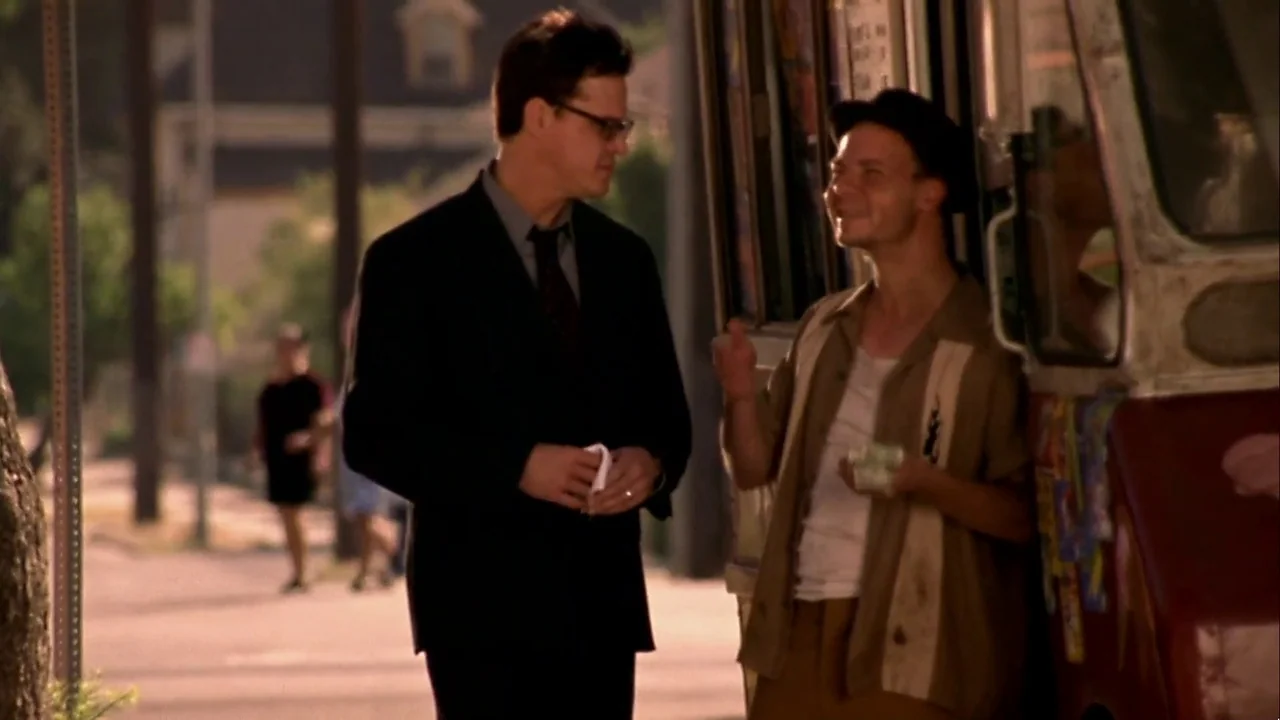 Hellraiser: Inferno (2000) movie still: medium — A man in a suit stands on a sidewalk next to an ice cream truck. He is having a conversation with…