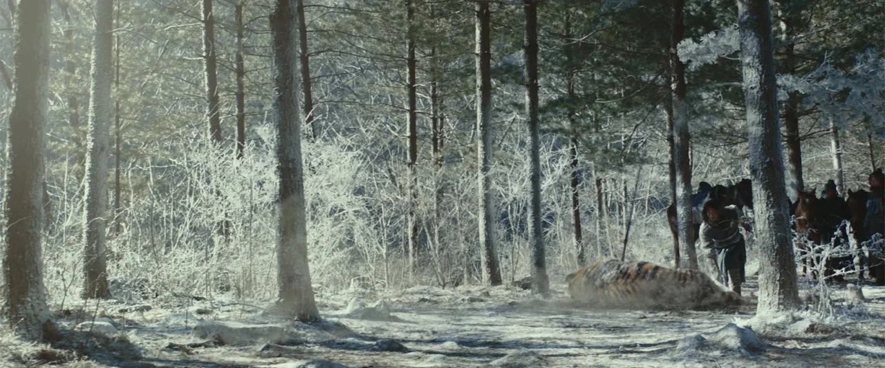 Along with the Gods: The Last 49 Days (2018) movie still: wide — A frost-covered pine forest fills the frame with a path cutting through the center.…