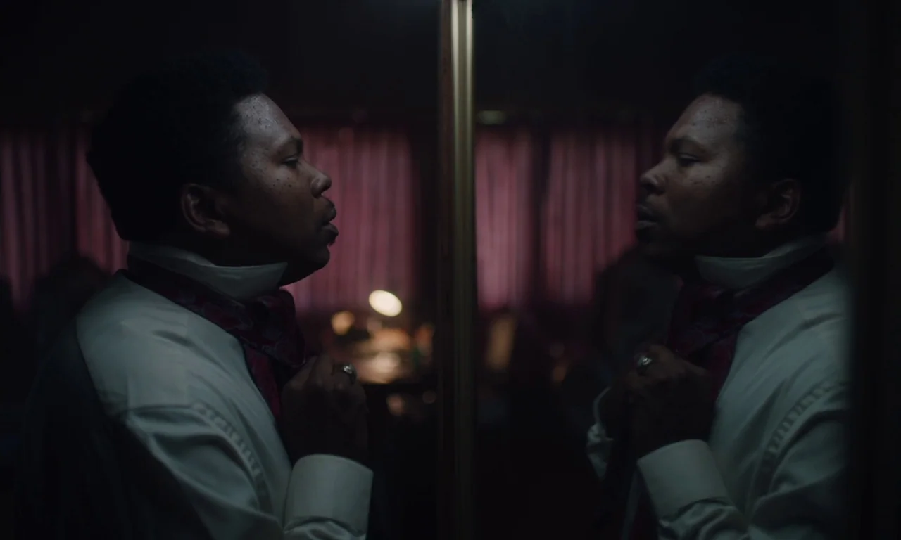 The Last Black Man in San Francisco (2019) movie still: medium — A dimly lit space containing a reflective mirror surface and dark red heavy…