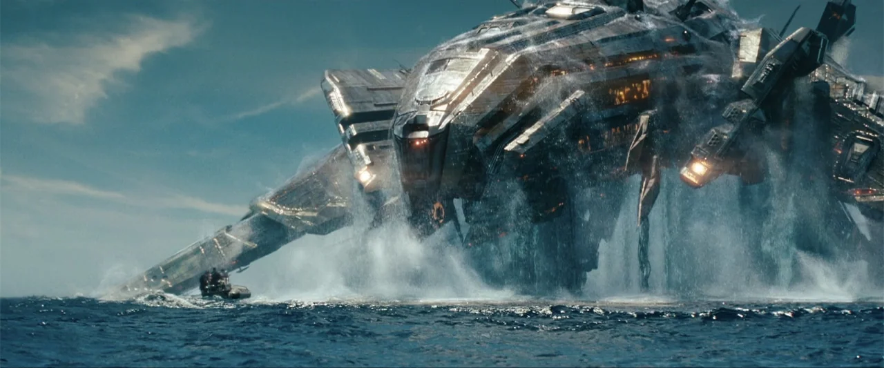 Battleship (2012) movie still: wide — A gargantuan metallic structure emerges forcefully from the dark blue surface of the open ocean. Water…