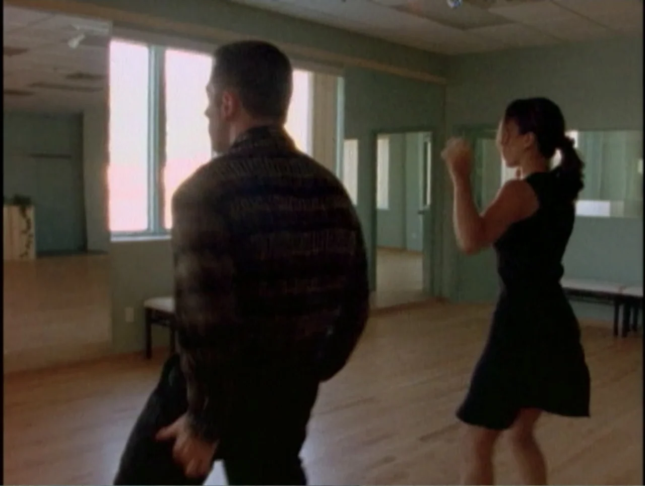 America Undercover: Life Afterlife (2000) movie still: fullbody — A sunlit dance studio features light wood floors and large windows against green…