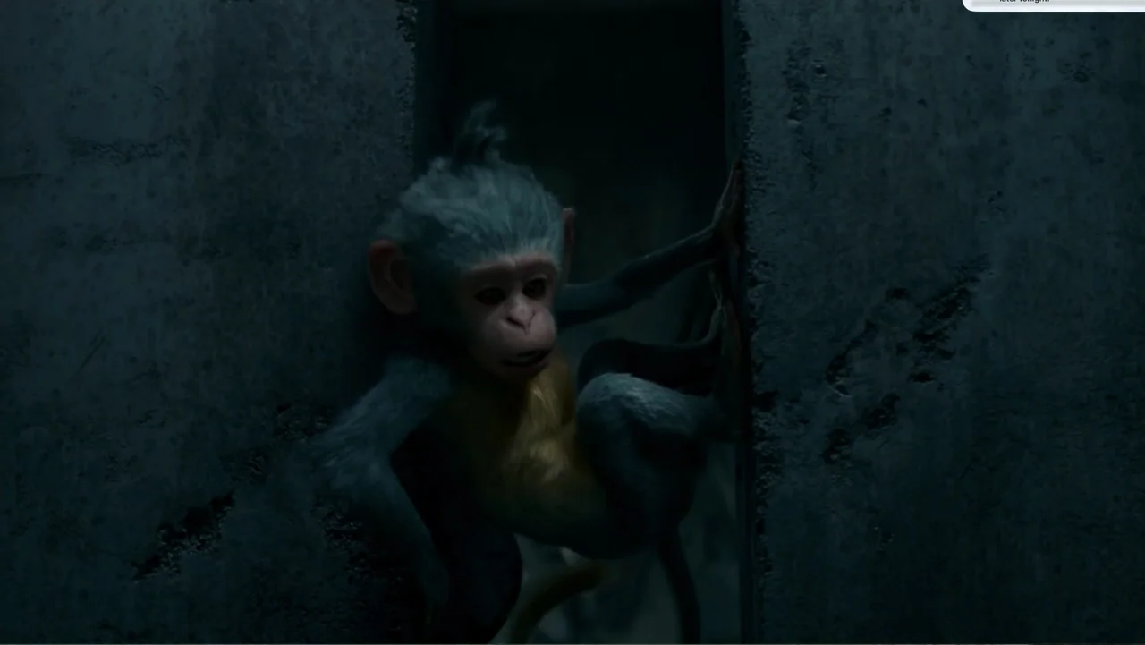 Dora and the Lost City of Gold (2019) movie still: medium — A small monkey character with grey and gold fur clings to a concrete crevice. The animal…