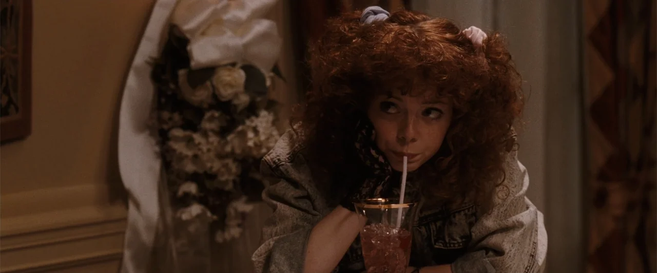 Ghosts of Girlfriends Past (2009) movie still: medium — A dimly lit indoor space features floral decorations and dark wood paneling. A young woman…