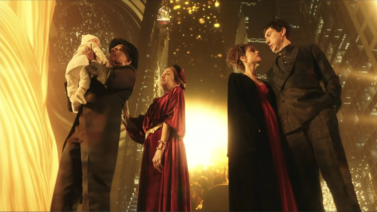 Megalopolis (2024) movie still: fullbody — A group of people stands in a dark urban environment with towering skyscrapers. Four individuals gather…