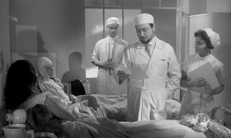 Eyes Without A Face (1960) movie still: medium — A hospital ward interior features a doctor, nurses, and patients in clinical white attire. A doctor…