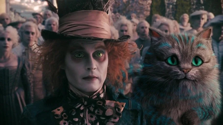Alice in Wonderland (2010) movie still: medium — A crowd of people in 18th-century style costumes stands behind a central man and cat. The man wears…
