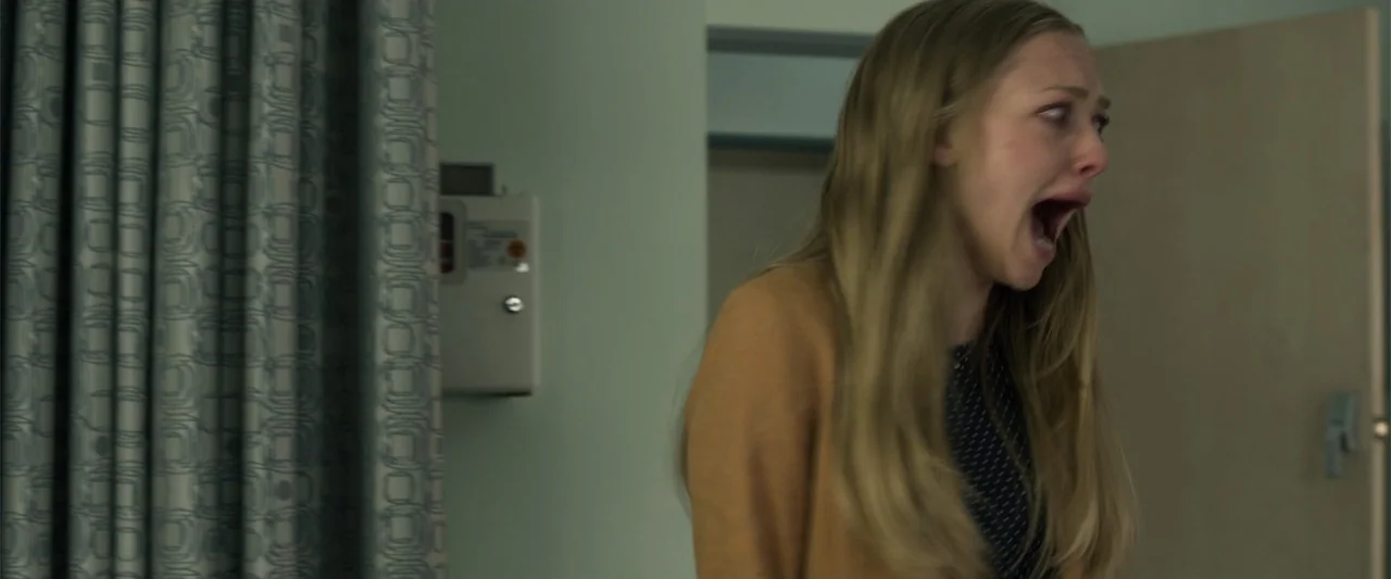 Ted 2 (2015) movie still: medium — A sterile medical setting features pale walls and a patterned privacy curtain. A young woman with long blonde…