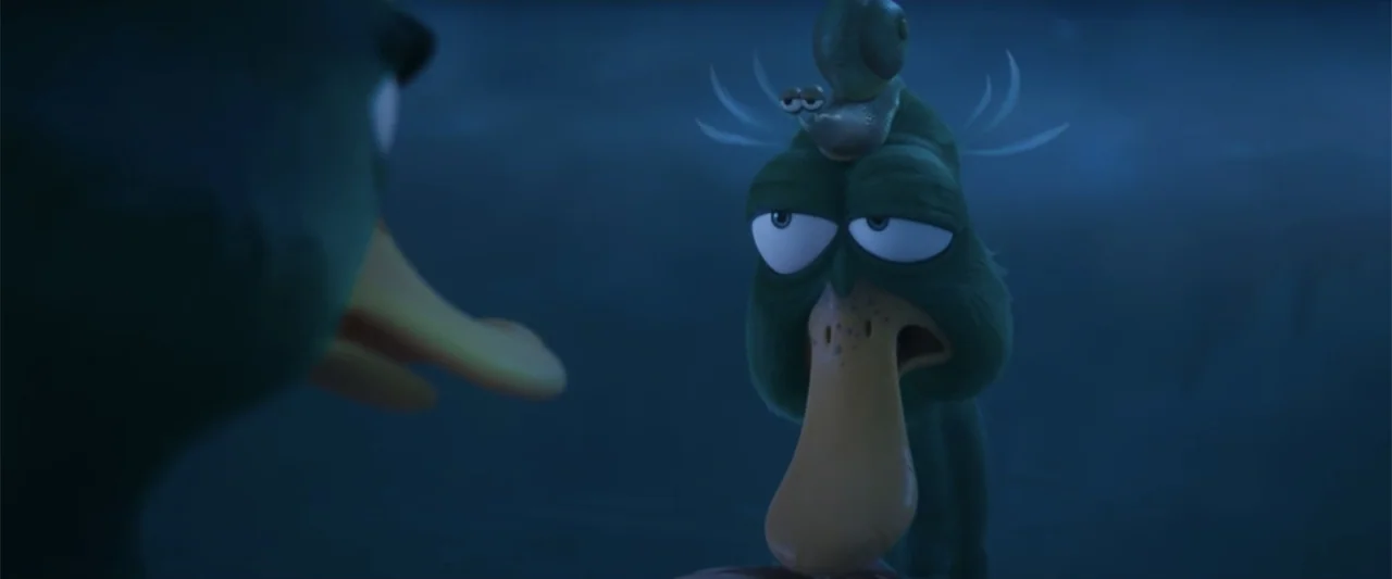 Migration (2023) movie still: medium — A dark blue watery environment with soft diffused light across the scene. A green anthropomorphic duck sits…