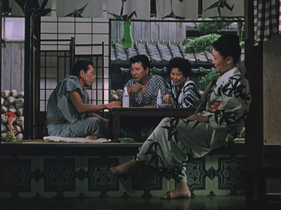 Floating Weeds (1959) movie still: medium — A traditional Japanese room features shoji screens, tatami mats, and an outdoor courtyard view. Four…