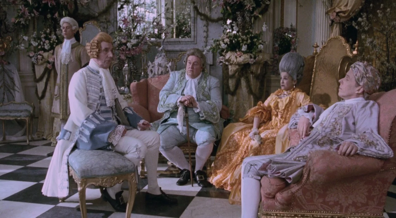 Orlando (1992) movie still: wide — An opulent 18th-century drawing room decorated with extensive floral arrangements and gold-trimmed furniture.…