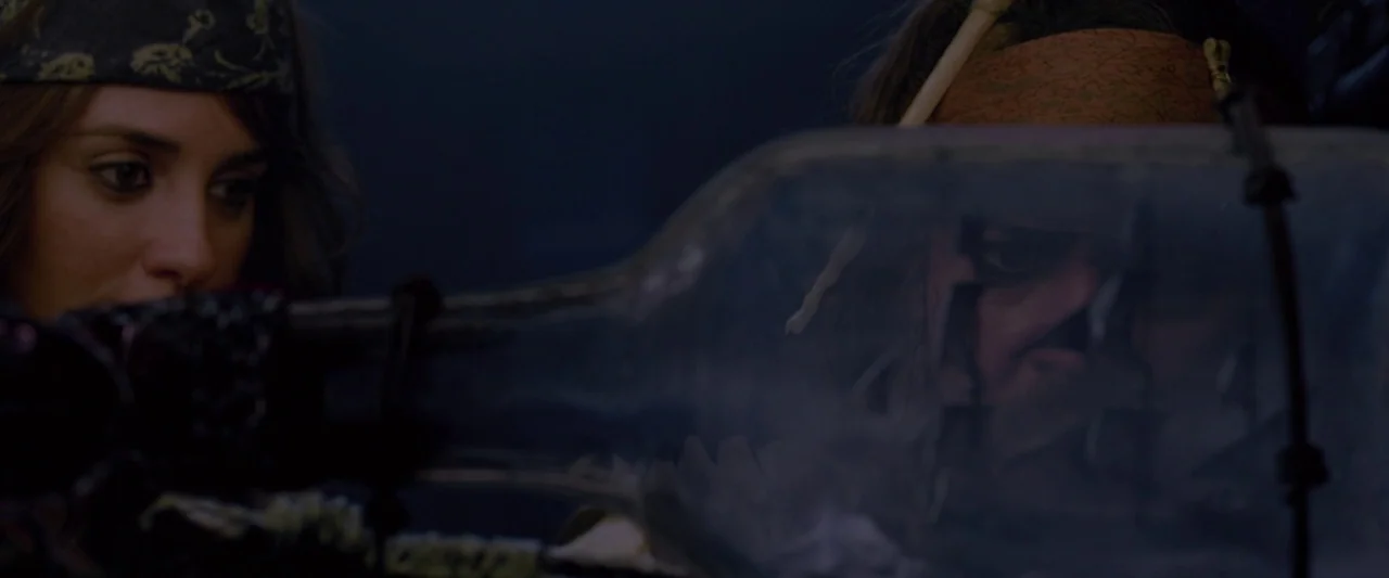 Pirates of the Caribbean: On Stranger Tides movie still: medium — A dimly lit cabin interior features a woman and a man looking at objects. They…