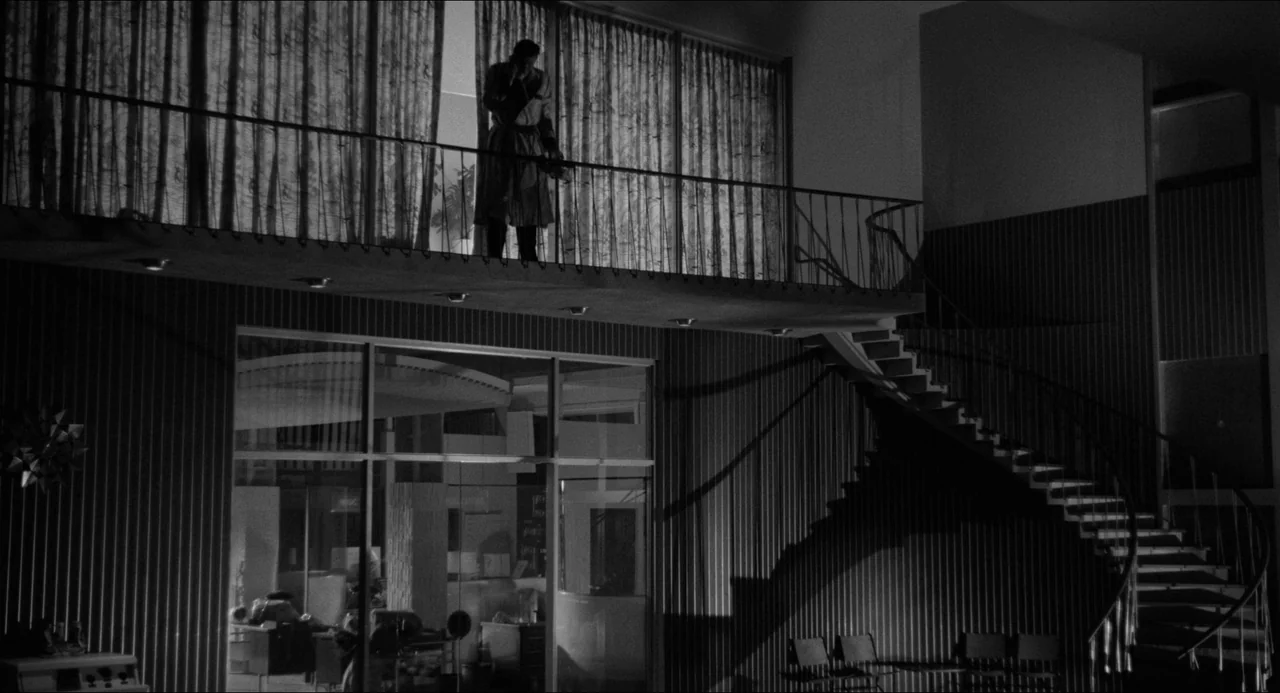 A Face In The Crowd (1957) movie still: wide — A modern two-story residence features a spiral staircase and large windows with floor-to-ceiling…