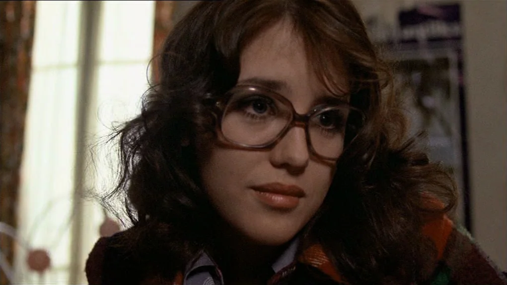 The Tenant (1976) movie still: closeup — A residential bedroom interior with window light illuminating a person from the side. A woman with dark…