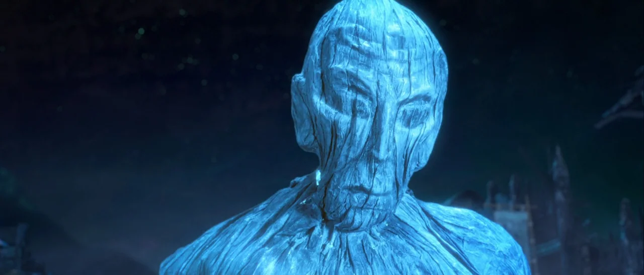 Kubo and the Two Strings movie still: closeup — A dark night setting features a large creature made entirely of weathered blue wood. The creature…