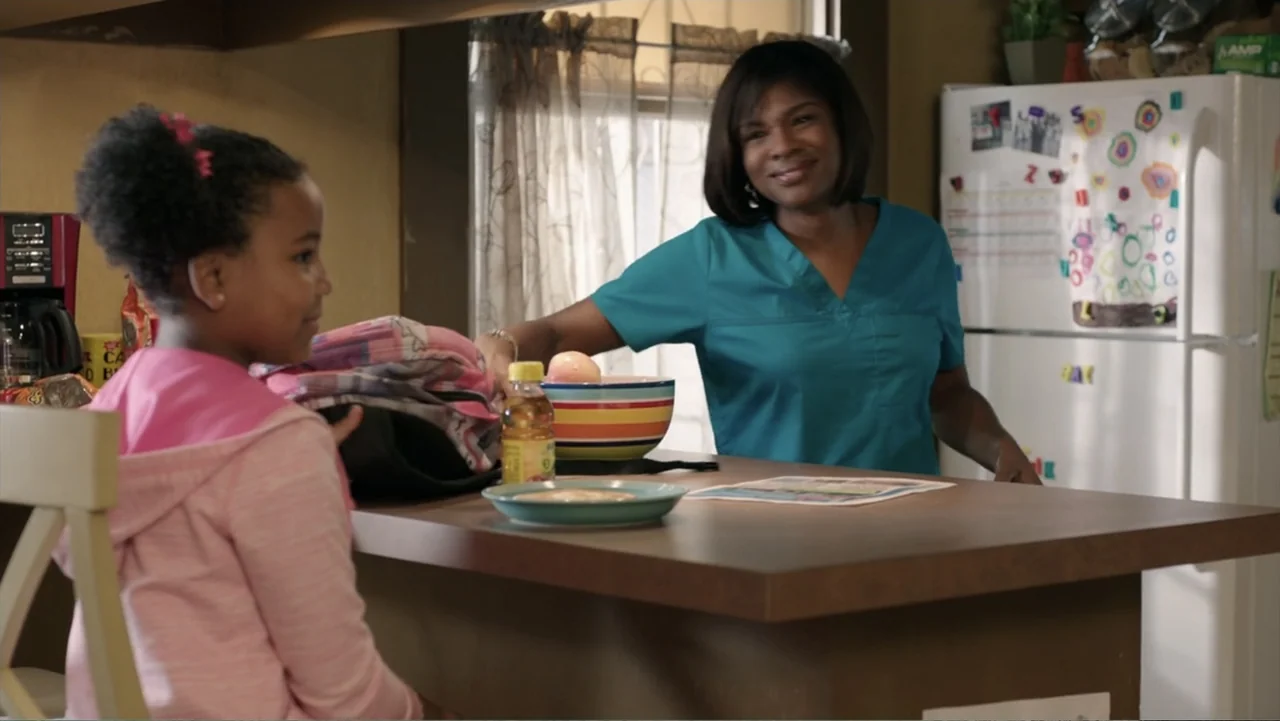 Get Hard (2015) movie still: medium — A residential kitchen counter features a white refrigerator covered in colorful children's magnets. A woman in…