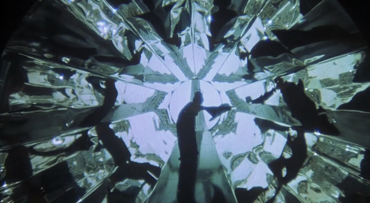 Dr. Phibes Rises Again (1972) movie still: wide — A kaleidoscope interior features repeating geometric mirrored panels forming a symmetrical…