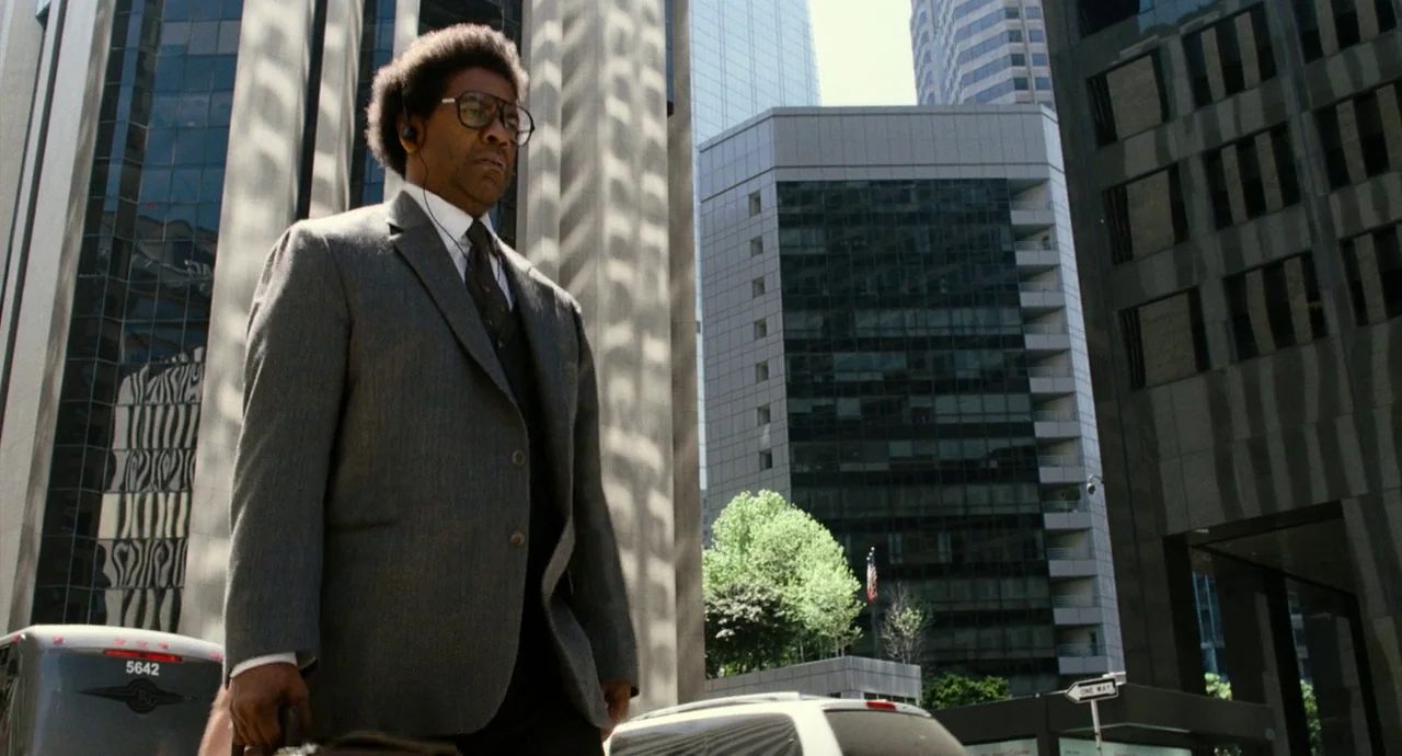Roman J. Israel, Esq. (2017) movie still: medium — A dense urban intersection surrounded by tall reflective glass-fronted commercial office towers.…